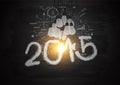 Vector bright light bulb illuminate the number 2015 on blackboard