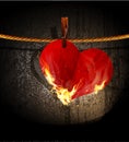 Vector burning heart hanging on a rope
