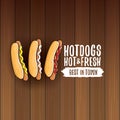 Vector cartoon hotdogs label isolated on wooden table background. Vintage hot dog poster or icon design element Royalty Free Stock Photo