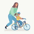 Mother teaching girl to ride the bike.