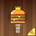 Vector cartoon royal king burger with cheese and golden crown icon on on wooden table background.