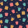Vector Christmas seamless pattern with different presents on dark blue background. Cute funny repeat texture of new year symbols. Royalty Free Stock Photo