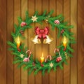 Vector Christmas Wreath with gold bells, red berries, candle, candy canes, bow, balls on wooden board background. Royalty Free Stock Photo