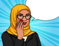 Muslim woman in a traditional scarf and glasses is whispering.