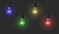 Vector, 3D realistic colored light bulbs glowing on a black background. Royalty Free Stock Photo