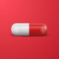 Vector 3d Realistic Red and White Pharmaceutical Medical Pill, Capsule, Tablet on Blue Background. Front View. Copy Royalty Free Stock Photo