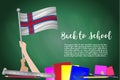 Vector flag of Faeroe Islands on Black chalkboard background. Education Background with Hands Holding Up of Faeroe Islands flag. B