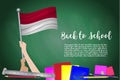 Vector flag of Indonesia on Black chalkboard background. Education Background with Hands Holding Up of Indonesia flag. Back to sc