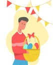 Happy young man holding basket of Easter eggs.