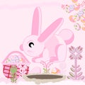 Pink rabbit near the hole sitting with a basket of Easter eggs