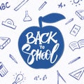 Vector hand drawn lettering of Back to School with apple and doodles supplies on sheet of exercise book background. Royalty Free Stock Photo