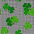 Vector houndstooth seamless black and white pattern with green shamrocks Royalty Free Stock Photo