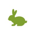 Vector icon with silhouette of sitting rabbit. Green summer bunny with cute long oval ears