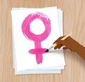 Female hand drawing woman symbol on paper Royalty Free Stock Photo