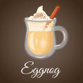 Christmas Eggnog. Hot cocktail with cinnamon and creamy foam. On brown background.