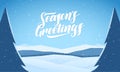 Blue mountains winter snowy landscape with hand lettering of Seasons Greetings and pines on foreground Royalty Free Stock Photo