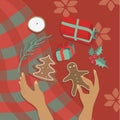 Vector illustration christmas still life, flat lay with gingerbread cookies, female hands, holly leaves and gift boxes on red tabl