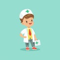 Vector illustration of cute little doctor standing with medical suitcase in hand. Boy character dressed in white coat Royalty Free Stock Photo