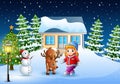 Cute little girl with a deer in front of snowy house in christmas day Royalty Free Stock Photo