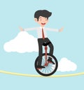 Businessman riding unicycle  on a rope Royalty Free Stock Photo