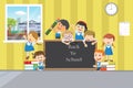 Group of happy school children with chalkboard in clasroom. Royalty Free Stock Photo