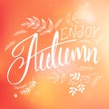 Vector illustration of hand lettering label - enjoy autumn - with doodle brunches and leaves