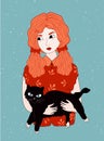 Redheaded girl holding black cat