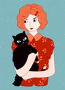 Redheaded girl holding black cat