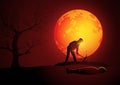 Killer wearing hoody digging a grave for his victim during full moon