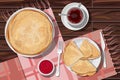 Vector illustration of pancakes folded in triangle and in stack in plates, jam and tea in cup on wooden table with towels.