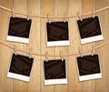 Vector illustration with photo frames hanging on a clothesline. Photographs with clothespins and ropes on wooden background Royalty Free Stock Photo