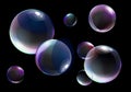 Vector illustration of realistic soap bubbles with bright rainbow colors on black background. Royalty Free Stock Photo