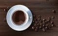 Vector illustration of a realistic style of white coffee cup with a saucer and coffee beans, top view Royalty Free Stock Photo