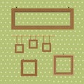 Set of wooden decorated frames hanging on the background of wallpaper in polka dots