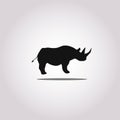 Vector illustration of a silhouette of a rhino standing on isolated white background. Rhinoceros side view profile. Royalty Free Stock Photo