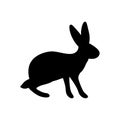 Vector illustration of a standing rabbit. Black silhouette of a hare on a white background. Doodle Style