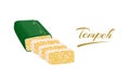 Tempe or tempeh, made from soybeans in environmentally friendly banana leaf packaging, isolated on white back
