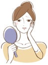 A woman troubled looking at his face with a hand mirror Royalty Free Stock Photo