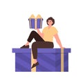 A man is sitting on a gift. Trendy character style.