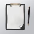 Black clipboard with a white blank sheet of paper and ballpoint pen Royalty Free Stock Photo