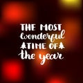 Vector The Most Wonderful Time of the Year lettering design on blurred background. Christmas or New Year typography. Royalty Free Stock Photo