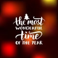 Vector The Most Wonderful Time of the Year lettering design on blurred background. Christmas or New Year typography. Royalty Free Stock Photo