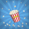 Vector Popcorn bucket with flying popcorn on blue pop art background. Royalty Free Stock Photo