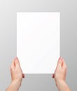 Vector realistic hands holding blank paper page isolated on grey background