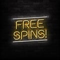 Vector realistic neon sign of Free Spins logo for decoration and covering on the wall background. Concept of bonus and ca