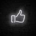 Vector realistic white Thumb Up neon symbol on dark brick wall