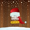 Vector red Santa hat with greeting text Merry Christmas and happy new year on wooden background with falling snowflakes Royalty Free Stock Photo