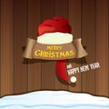 Vector red Santa hat with paper banner and greeting text Merry Christmas and Happy new year on wooden background. Royalty Free Stock Photo