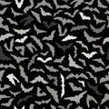 Vector seamless background for Halloween design. Seamless pattern with gray flying bats isolated on black background Royalty Free Stock Photo