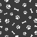 Vector, seamless pattern. Abstraction,, white traces of paws of a cat, dog, bones on a dark gray background. For prints, packaging Royalty Free Stock Photo